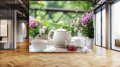 Elegant tea party with herbal tea served in fine china. The table is decorated with flowers and herbs Wall mural