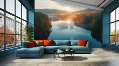 Aerial view of sunrise over a calm lake surrounded by forest, peaceful morning light on the water Wall mural