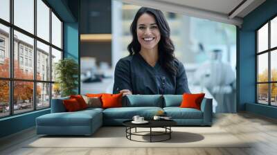 Beautiful and confident Caucasian female dentist with a friendly smile standing inside a blurry modern clinic Wall mural