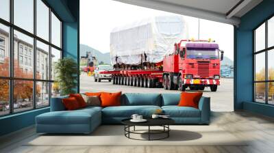 Transport of Oversize Heavy Machinery cargo truck Loading a new locomotive port area Wall mural