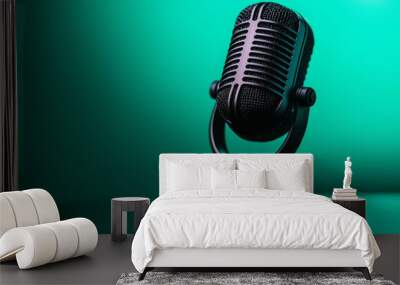 A black podcast microphone on mint background Wall mural