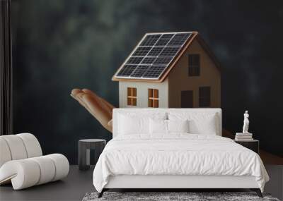 Hand holding a house with solar panels installed on the roof Wall mural