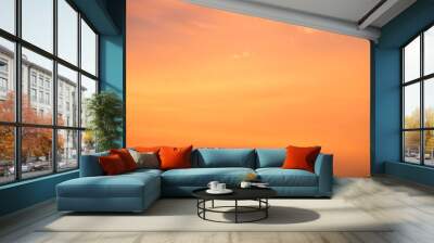 Orange cloudy sky with evening sun background Wall mural