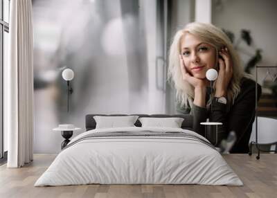 Beautiful blonde woman drinking coffee, happiness, smile, natural light Wall mural