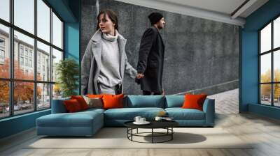 Beautiful couple in stylish clothes in gray tones, city Wall mural