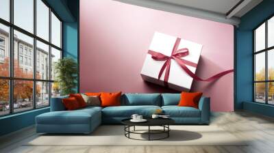 White gift box with red ribbon on pink background, christmas day present. A box for surprise in holiday. Wall mural