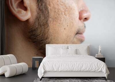 Side view of Asian man face with beard grows on a part of lower face. Beard is the collection of hair that grows on the chin, upper lip, cheeks and neck of humans. Wall mural