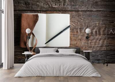 The leather book on the wood table. Wall mural