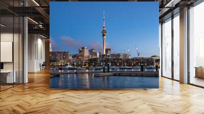 Twilight view of sky tower view from Viaduct Harbour in the central of Auckland, New Zealand. Auckland is New Zealand's largest city and the centre of the country's retail and commercial activities. Wall mural