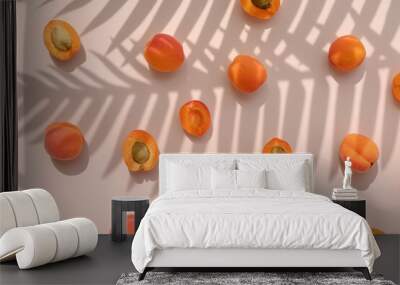 Apricot fruit with palm leaves shadow on a pastel pink background. Summer aesthetic concept. Wall mural