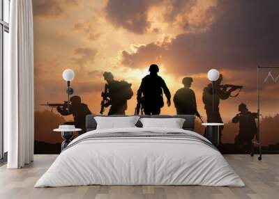 Six military silhouettes on sunset sky background Wall mural