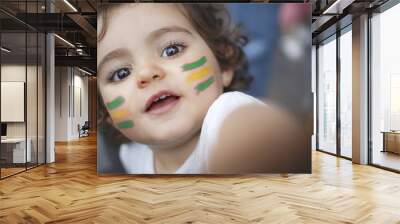 Kid fan green and yellow flag painted on face Wall mural