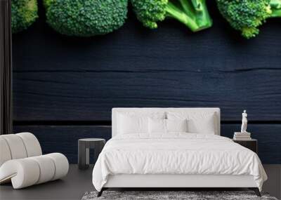 Fresh broccoli arranged neatly on a dark wooden table Wall mural