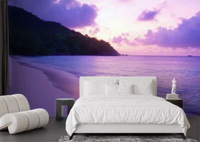 Tropical beach at dusk with gentle waves and vibrant sky colors Wall mural