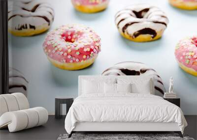 Donut with pink icing and star sprinkles on the top on blue background. Selective focus. Wall mural