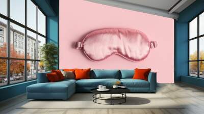 Pink silk sleeping mask on a pastel pink background Wall mural