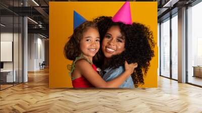 Afro daughter and mother are happy together. Wall mural