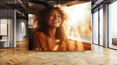 Closeup portrait of a cheerful young woman with windy hair sitting at a car. Generative AI. Wall mural