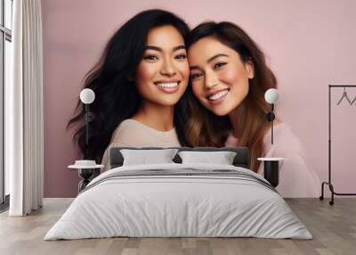 Two beautiful Asian girls smiling hugging each other on pastel background. Generative AI. Wall mural