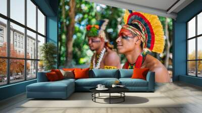 two Indians from the Pataxó tribe. Brazilian Indian from southern Bahia with feather headdress, necklace and traditional facial paintings looking to the left Wall mural