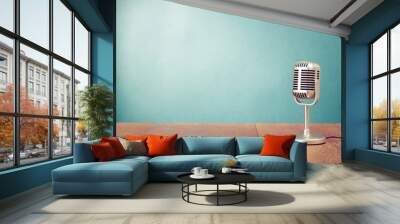 Retro style microphone on table in front aquamarine wall Wall mural