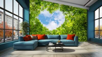 Green leaves background, blue sky heart shape cloud ecology concept idea eco love symbol background abstract Wall mural