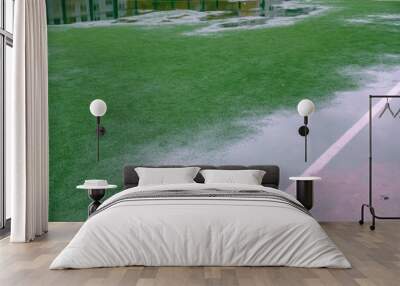 Rain Soccer field with grass green football. line turf Wall mural