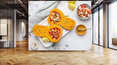 Halved roasted butternut squash with spicy vegetable filling and feta cheese Wall mural