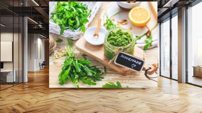 Homemade arugula pesto with ingredients on wooden background Wall mural