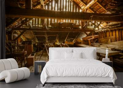 Interior of old wooden shed with scrap wood with sunrays Wall mural