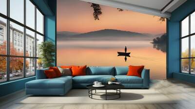 Rolling hills meet a crystal-clear lake, reflecting the vibrant hues of a setting sun. One figure standing at the water's edge, bathes in the golden glow of dusk. Wall mural