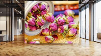 Many naturally dried rose buds on the table Wall mural