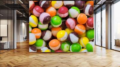 Freeze dried Skittles hard candy split centers, colorful sweet food treat background. Wall mural