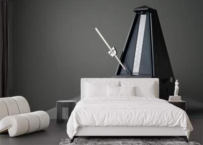 Monochromatic metronome in action isolated and on a plain background Wall mural