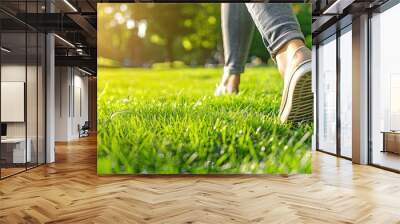 closeup photo of well-pedicured feet walking on fresh green grass Wall mural