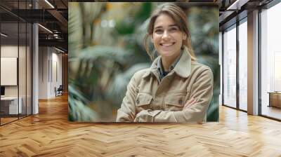 Friendly female zoologist standing outside an animal display Wall mural