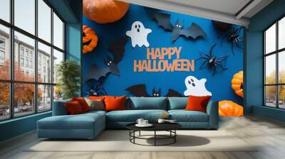 halloween frame with party decorations of pumpkins, bats, ghosts, spiders on blue background from above Wall mural