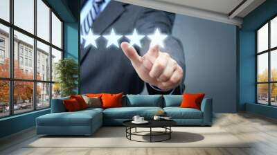 Businessman pointing to five star service rating symbol Wall mural