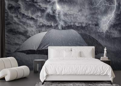 Businessman with umbrella sheltering from approaching storm Wall mural