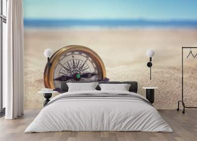 Compass on the beach with sand and sea Wall mural