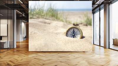 Compass on the beach with sand and sea Wall mural