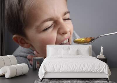 Sick boy taking medicine Wall mural