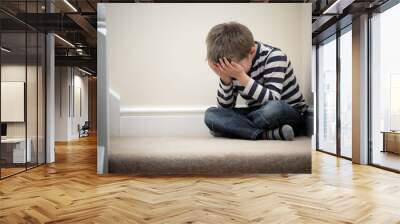 upset problem child sitting on staircase Wall mural