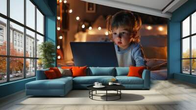 Perplexed young child using laptop Wall mural