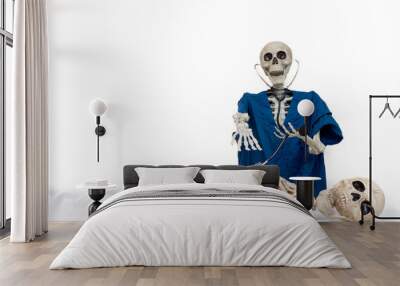 Skeleton doctor wearing blue scrubs uses stethoscope to examine patient lying on hospital bed with shocked and horror look on face after dying waiting for medical care Wall mural