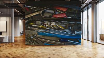 A view top down looking into the over loaded tool tray in the dirty old workshop.  Wall mural