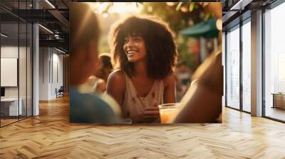 A diverse group of african friends shares joy, laughter, and a delicious meal outdoors, celebrating togetherness in a multicultural gathering Wall mural