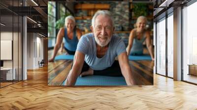 Energetic seniors performing yoga in bright room, three elderly individuals in casual blue and gray attire, daily fitness routine. Wall mural