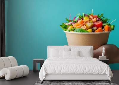 vibrant asian street food delivery concept with hand holding colorful salad bowl against turquoise b Wall mural