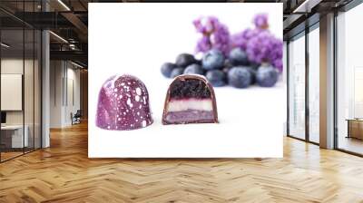 Chocolate candy in a cut on a white background. Blueberry and lavender flavor and taste. Blurred ingredients on background Wall mural